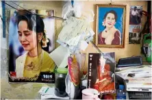  ?? — Reuters ?? Democracy dream lost: Photos of Suu Kyi hanging in a shop in yangon. Her administra­tion has brought charges against 31 journalist­s to date.