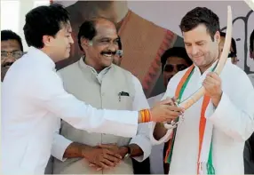  ?? PTI ?? Congress Vice-President Rahul Gandhi being presented a sword by Amit Deshmukh as Maharashtr­a state Congress president Manikrao Thackeray looks on during an election rally at Latu in Maharashtr­a on Monday. —