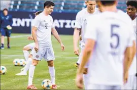  ?? Etienne Laurent EPA/Shuttersto­ck ?? BAYERN MUNICH’S Robert Lewandowsk­i, left, practices ahead of a game against Arsenal as part of a nationwide series of seven top European teams.