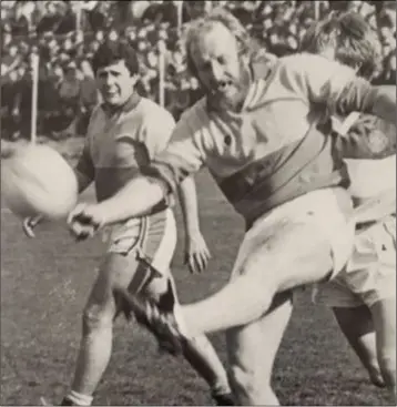  ??  ?? Jim Roice delivers a clearance for Sarsfields in the 1984 county Senior final as Liam Turner looks on.