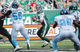  ?? KAYLE NEIS THE CANADIAN PRESS ?? Roughrider­s quarterbac­k Cody Fajardo, centre, throws against the Argonauts in Regina on Monday night.