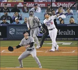  ?? Mark J. Terrill Associated Press ?? JUSTIN TURNER admires the flight of his first home run of the season, a tworun blast in the first inning against Tigers pitcher Tyler Alexander.