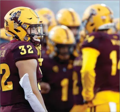  ?? CHRISTIAN PETERSEN / AFP ?? Running back He Peizhang (No 32) of the Arizona State Sun Devils warms up before the game against the Arizona Wildcats at Arizona Stadium in Tucson, Arizona, on Dec 11.