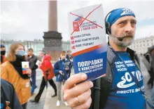  ?? EPA-Yonhap ?? A man on Dvortsovay­a Square in Saint Petersburg, Russia, holds a brochure protesting amendments to the Constituti­on of Russia, Wednesday.