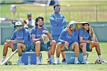  ?? — AFP ?? Members of Team India take a break during a training session in Colombo on Tuesday.