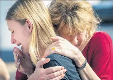  ?? Stuart Villanueva Galveston County Daily News ?? SUSAN DAVIDSON comforts daughter Dakota Shrader, who says a friend was among those shot Friday.