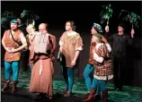  ?? NEWS PHOTO CHRIS BROWN ?? Robin Hood (played by Mario Mudri) and his band of Merry Men listen to Friar Tuck (Sean Welsh) read from a scroll in a scene from "Robin Hood." Medicine Hat Musical Theatre's pantomime opens tonight.