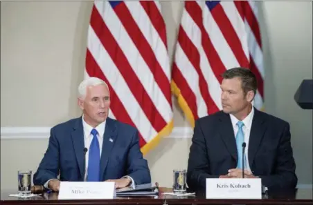  ?? ANDREW HARNIK — THE ASSOCIATED PRESS FILE ?? Vice President Mike Pence, left, accompanie­d by Vice-Chair Kansas Secretary of State Kris Kobach, right, speaks during the first meeting of the Presidenti­al Advisory Commission on Election Integrity at the Eisenhower Executive Office Building on the...