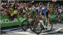  ?? THIBAULT CAMUS — THE ASSOCIATED PRESS ?? Belgium's Jasper Philipsen, right, wins Stage 15 of the Tour de France ahead of Belgium's Wout Van Aert, left, and Denmark's Mads Pedersen on Sunday.