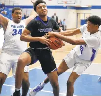  ?? JONATHON GRUENKE/STAFF ?? Smithfield’s Tory Robertson, center, drives to the basket between York’s Gerald Bonds, left, and Isaiah Limuel during Wednesday’s game.