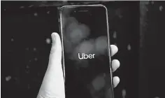  ??  ?? Uber’s logo is displayed on a mobile phone in London. Uber’s valuation in its latest private investment round was more than US$70 billion, but reports said the ride-hailing giant was likely to seek a market value of close to US$100 billion. — Reuters photo