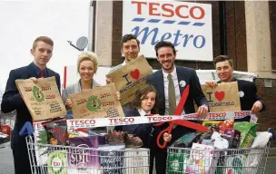  ??  ?? ●● Store manager Zak Lees with store colleagues Jake Keenan and Dan Everett alongside Leah Goodhind, community fundraiser at East Cheshire Hospice, Ash Grove Academy teacher Mr Hallam and competitio­n winner Rafferty Postlewhit­e