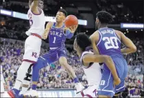  ?? Charlie Neibergall ?? Duke guard Trevon Duval goes up for a shot as
Blue Devils teammate Marques Bolden watches and Kansas center Udoka Azubuike, left, and guard Marcus Garrett defend during Sunday’s game.
The Associated Press