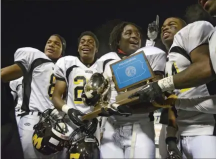  ?? RALPH WILSON — THE ASSOCIATED PRESS ?? Archbishop Wood players show their fans the championsh­ip trophy at the end of a PIAA high school Class AAA championsh­ip football game against Harrisburg’s Bishop McDevitt in Hershey, Pa. on Friday, Dec. 13, 2013.