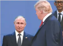  ?? AFP-Yonhap ?? U.S. President Donald Trump looks at Russia’s President Vladimir Putin as they take place for a family photo, during the G20 Leaders’ Summit in Buenos Aires, Nov. 30, 2018.