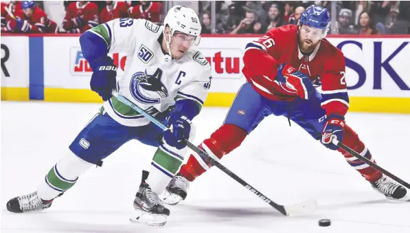  ?? — GETTY IMAGES ?? Vancouver Canucks captain Bo Horvat, shown duelling for the puck with the Montreal Canadiens’ Jeff Petry earlier this season, says many issues still remain to be resolved if the NHL is to move forward with plans to resume its season during the summer months.