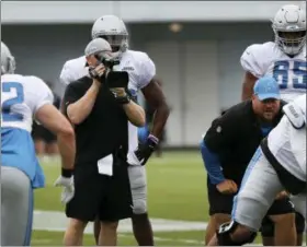  ?? CARLOS OSORIO — THE ASSOCIATED PRESS ?? In a photo from a Detroit Lions cameraman videos a play during NFL football practice in Allen Park, Mich. The Lions are among the teams in the league making instant replay available to make quick correction­s and observatio­ns.