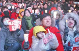  ?? Photo: Xinhua ?? People attend a rally demanding President Park Geun-hye to step down in central Seoul, South Korea.