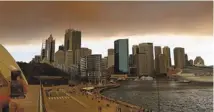  ?? GREG WOOD/AFP/GETTY IMAGES ?? Smoke and ash from wildfires burning across the state of New South Wales blanket the Sydney skyline Thursday.