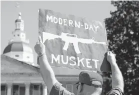  ??  ?? A demonstrat­or holds a sign to show his opposition to gun control legislatio­n. The Annapolis rally drew 200 to 300 people.