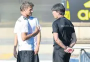  ??  ?? Germany midfielder Thomas Mueller, left, speaks with coach Joachim Loew during a training session in Stuttgart.