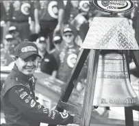  ??  ?? Kyle Larson rings the El Camino Real bell after his win in the NASCAR Cup Series auto race at Auto Club Speedway in Fontana Sunday.