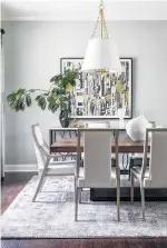  ??  ?? Mixed metals and contempora­ry lighting and chairs blend in this dining room.