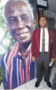  ?? ?? Cornwall College Head Boy Mattheou Dillon White, recipient of the Rex Nettleford Award of Excellence, stands beside the image of Nettleford at Little Theatre on Tuesday, February 13.