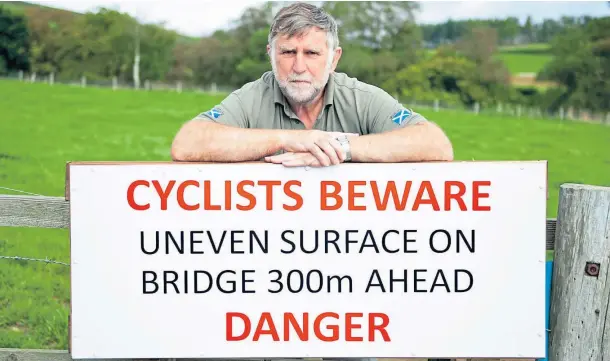  ??  ?? GO SLOW: Inveresk Community Council chair Gus Leighton with the road safety sign that he has paid for himself on the approach to Margie Bridge.