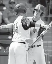  ?? AP/GERRY BROOME ?? Louisville’s Devin Mann (right) gets a hug from teammate Logan Wyatt after hitting a home run during the eighth inning Saturday as the Cardinals beat Pittsburgh 5-2 in Durham, N.C., to advance to the ACC Tournament championsh­ip game.