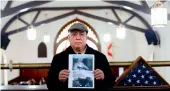  ?? — AFP ?? Miguel Perez holds a photo of his son Miguel Perez Junior, an Army veteran facing deportatio­n.