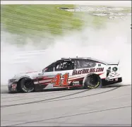  ?? Rob Carr / Getty Images ?? Cole Custer celebrates with a burnout after winning the NASCAR Cup Series Quaker State 400 at Kentucky Speedway on Sunday in Sparta, Ky.