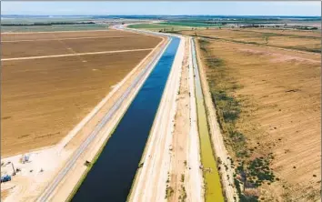  ?? Brian van der Brug Los Angeles Times ?? THE DELTA-MENDOTA CANAL, left, and a parallel canal in Firebaugh, Calif. “The whole water rights system sits on a foundation of racism and violence,” said a former staffer on the State Water Board.