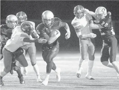  ?? STEVE RUARK/BALTIMORE SUN MEDIA GROUP ?? Glenelg running back Wande Owens carries the ball as lineman Jake Arnone, left, blocks New Town safety Antoine Collins Jr., second from left, and running back Will Jordan, right, blocks linebacker Jarren Driver, second from right, during the first half.