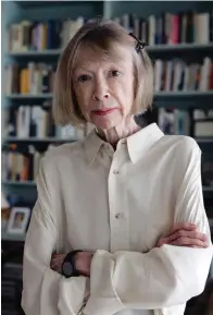  ?? The Associated Press ?? ■ Author Joan Didion stands in her apartment on Sept. 26, 2005, in New York. Didion, the revered author and essayist whose provocativ­e social commentary and detached, methodical literary voice made her a uniquely clear-eyed critic of a uniquely turbulent time, has died. She was 87.