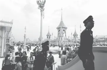  ??  ?? People attend the Royal Crematoriu­m for late King Bhumibol during a soft opening for public near the Grand palace in Bangkok, Thailand. — Reuters photo