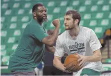  ?? staff fILE photo by Matt stoNE ?? VIEW FROM HIS PERCH: Celtics assistant coach Walter McCarty (left) has a unique perspectiv­e about the current NCAA recruiting scandal, as he used to be an assistant for deposed Louisville coach Rick Pitino.