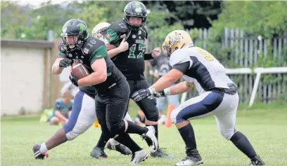  ?? Tim Furfie ?? Halton Spartans running back Martin Murphy attempts to make ground against the Bobcats.