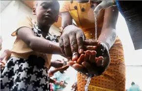  ??  ?? Preventive measure: A Congolese child washing her hands to protect against Ebola at the Church of Christ in Mbandaka, the Democratic Republic of Congo. — Reuters