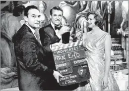  ?? Fox Photos / Getty Images ?? A SOUTHERN BOY ENCHANTED BY ASTAIRE Stanley Donen holds up the clapperboa­rd as Cary Grant and Ingrid Bergman mark the completion of 1958’s “Indiscreet,” one of the director’s nonmusical­s.