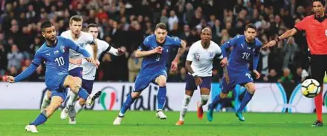  ?? AP ?? ■ Italy’s Lorenzo Insigne scores on a penalty during the internatio­nal friendly match against England at the Wembley Stadium in London on Tuesday. The match ended in a 1-1 draw.