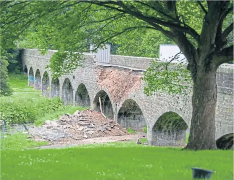  ??  ?? The side of the structure crumbled after a spell of torrential rain leading to the bridge being closed.