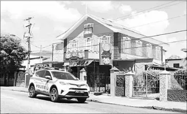  ??  ?? A police vehicle passes in front of Stir Fry Restaurant on Ariapita Avenue, Woodbrook, hours after a raid at the establishm­ent Wednesday morning.