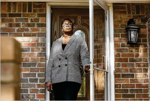  ?? PHOTOS BY NATRICE MILLER/NATRICE.MILLER@AJC.COM ?? STONECREST RESIDENT DEALT WITH MONTHSLONG SAGA
Dele Lowman, seen on her home’s front porch in October, has rented two single-family homes in her Stonecrest neighborho­od. Both were bought out of foreclosur­e by investment firms. Her current landlord, Ohio-based VineBrook Homes, bought them in early 2022 when it acquired the entire rental portfolio of nearly 3,000 homes nationwide from another private equity firm for $350 million.