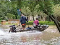  ??  ?? Members of the Cajun Navy (above and opposite) searching flooded streets of Southeast Texas for Harvey’s victims