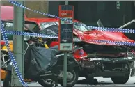  ?? EDGAR SU / REUTERS ?? The wreckage of a car is seen after it hit pedestrian­s in central Melbourne on Friday.