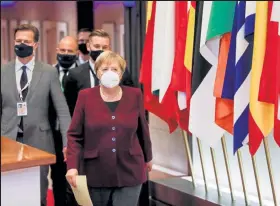  ?? Olivier Hoslet / Getty Images ?? German Federal Chancellor Angela Merkel leaves at the end of the two days face-to-face European Union summit at the European Council Building in Brussels, on Friday.