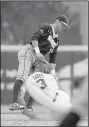  ?? NWA Democrat-Gazette/BEN GOFF ?? Arkansas’ Jason Gates collides with Harrison Smith of Oral Roberts after sliding safely into second base.