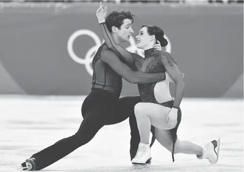  ?? MLADEN ANTONOV / AFP / GETTY IMAGES ?? Making magic with their eyes: The captivatin­g Tessa Virtue and Scott Moir perform at Pyeongchan­g.