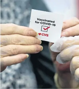  ?? MARCIO JOSE SANCHEZ/AP ?? A patient receives a sticker after receiving a shot of the Moderna COVID-19 vaccine at a CVS Pharmacy branch in Los Angeles.